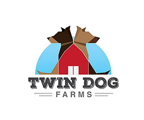 Twin Dog Farms logo with a red barn and two dog profiles